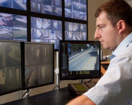 Man monitoring cctv cameras in modern control room